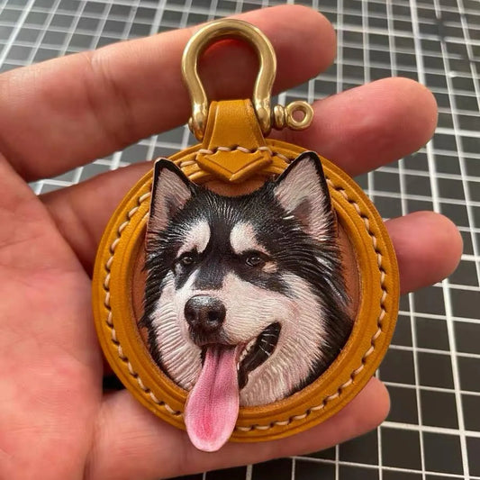 Custom Leather Pet Portrait Keychain with a dog's face design held in a hand against a beige background