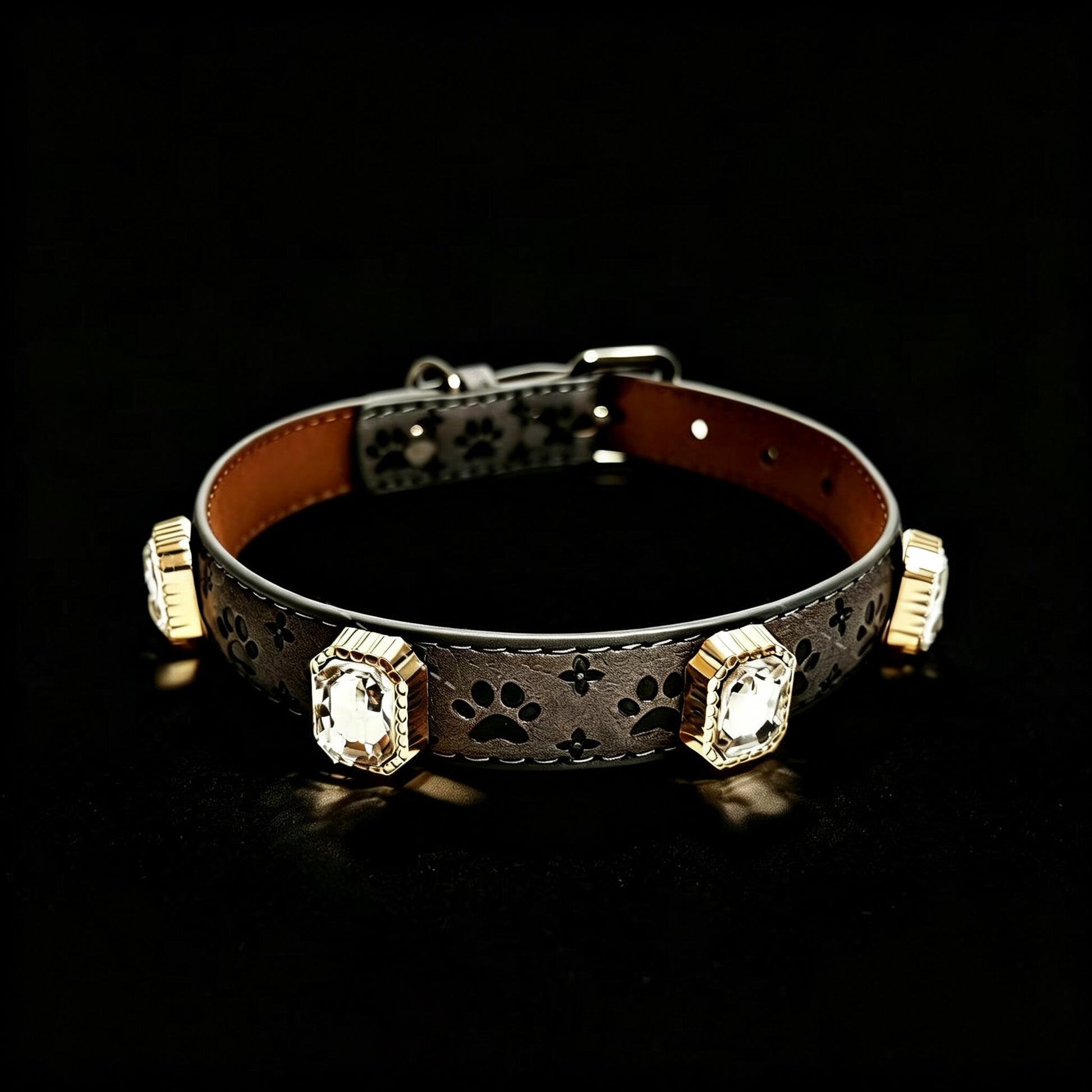 Decorative dog collar with paw prints and gemstones on a black background