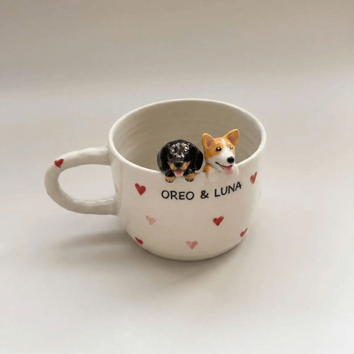 Custom pet Mug with two dog figurines and names 'Oreo' and 'Luna' on a light background