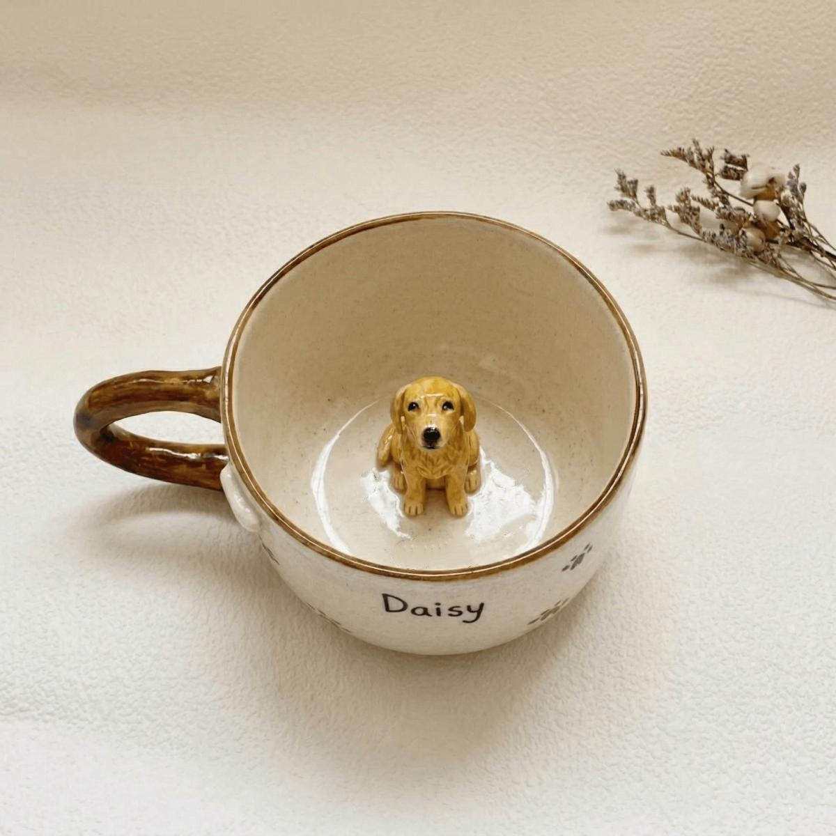 Ceramic mug with a small dog figurine inside, on a light background