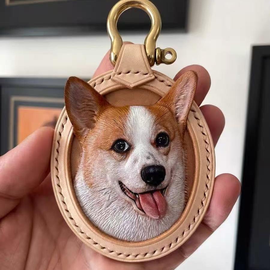 Custom Leather Oval Pet Portrait Keychain with a dog's face design held in a hand