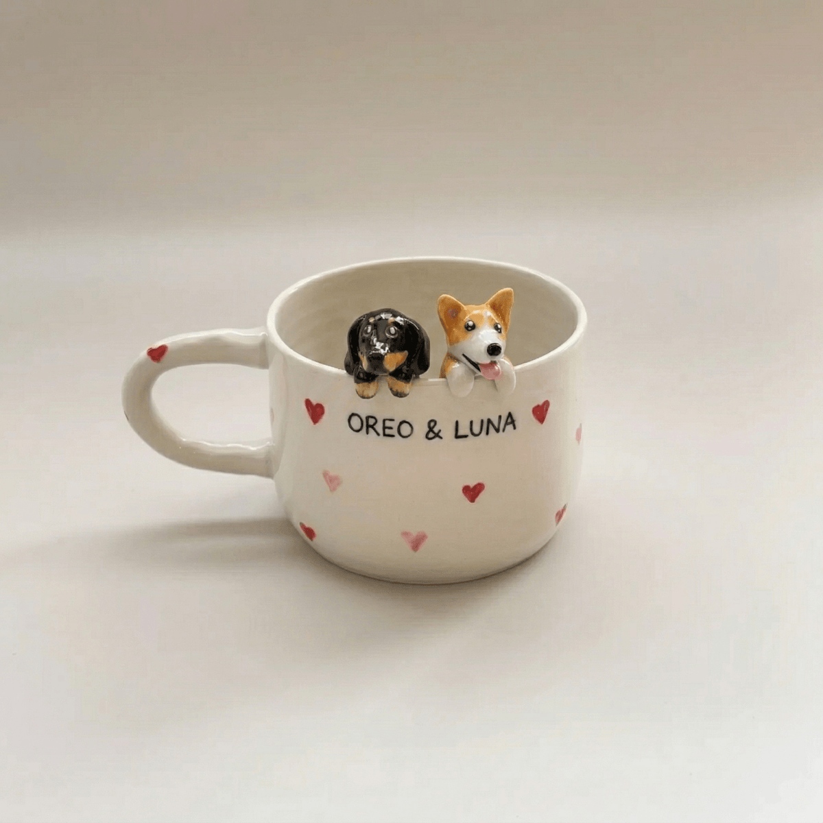 Custom pet Mug with two dog figurines and names 'Oreo' and 'Luna' on a light background