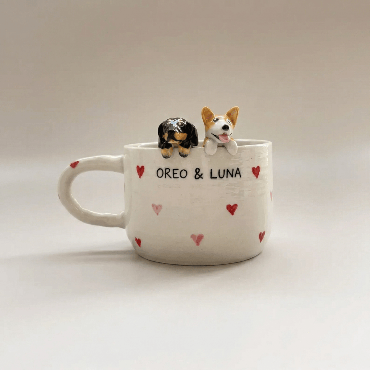 Custom pet Mug with two dog figurines and names 'Oreo' and 'Luna' on a light background