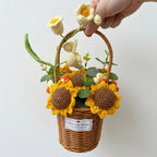 Handmade crochet flowers in a woven basket held by a hand on a white background