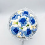 Bouquet of blue and white crocheted flowers on a light gray background