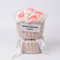 Bouquet of pink flowers in a decorative container with 'ROSE MEANS LOVE' text on a white background