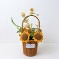 Handmade crochet sunflowers in a wicker basket on a white background