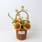 Handmade crochet sunflowers in a wicker basket on a white background