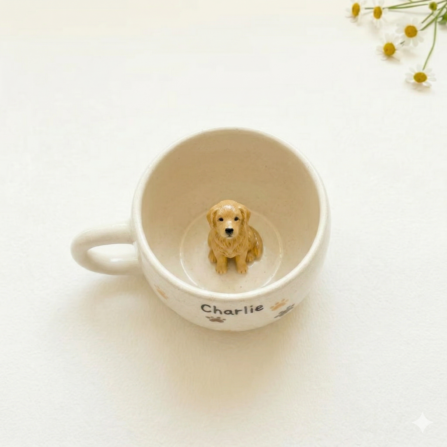 Custom pet ceramic mug with 'Charlie' and paw prints, featuring a small dog figurine on a light background.
