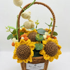 Crocheted sunflowers and flowers in a basket with a white background