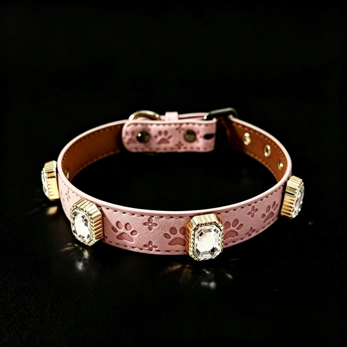 Pink dog collar with gold accents on a black background