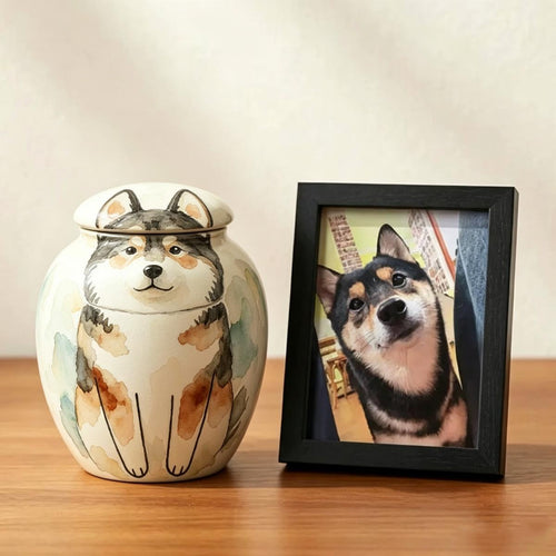 TimoPaw Custom pet ceramic urn with dog design next to a framed photo of a dog on a wooden surface.