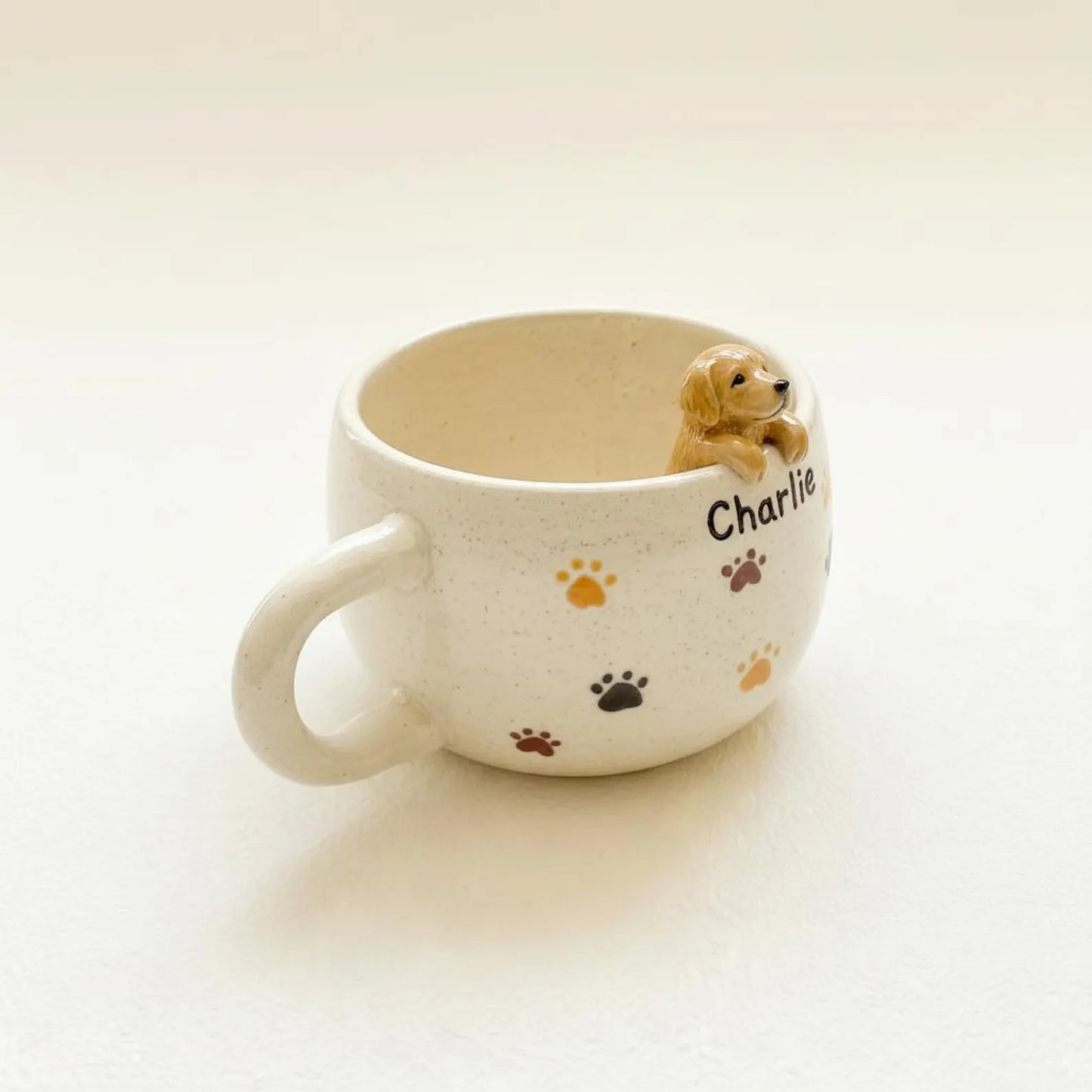 White mug with a small dog figurine and paw prints on a light background