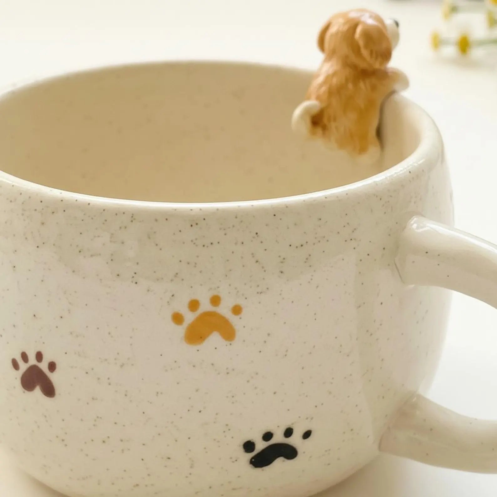 Custom pet ceramic mug with 'Charlie' and paw prints, featuring a small dog figurine on a light background.