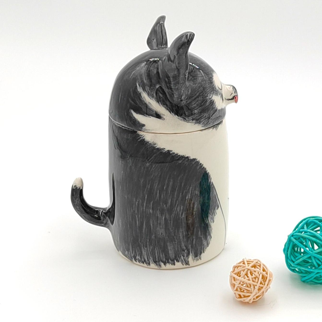 Ceramic badger-shaped jar with a lid on a white background