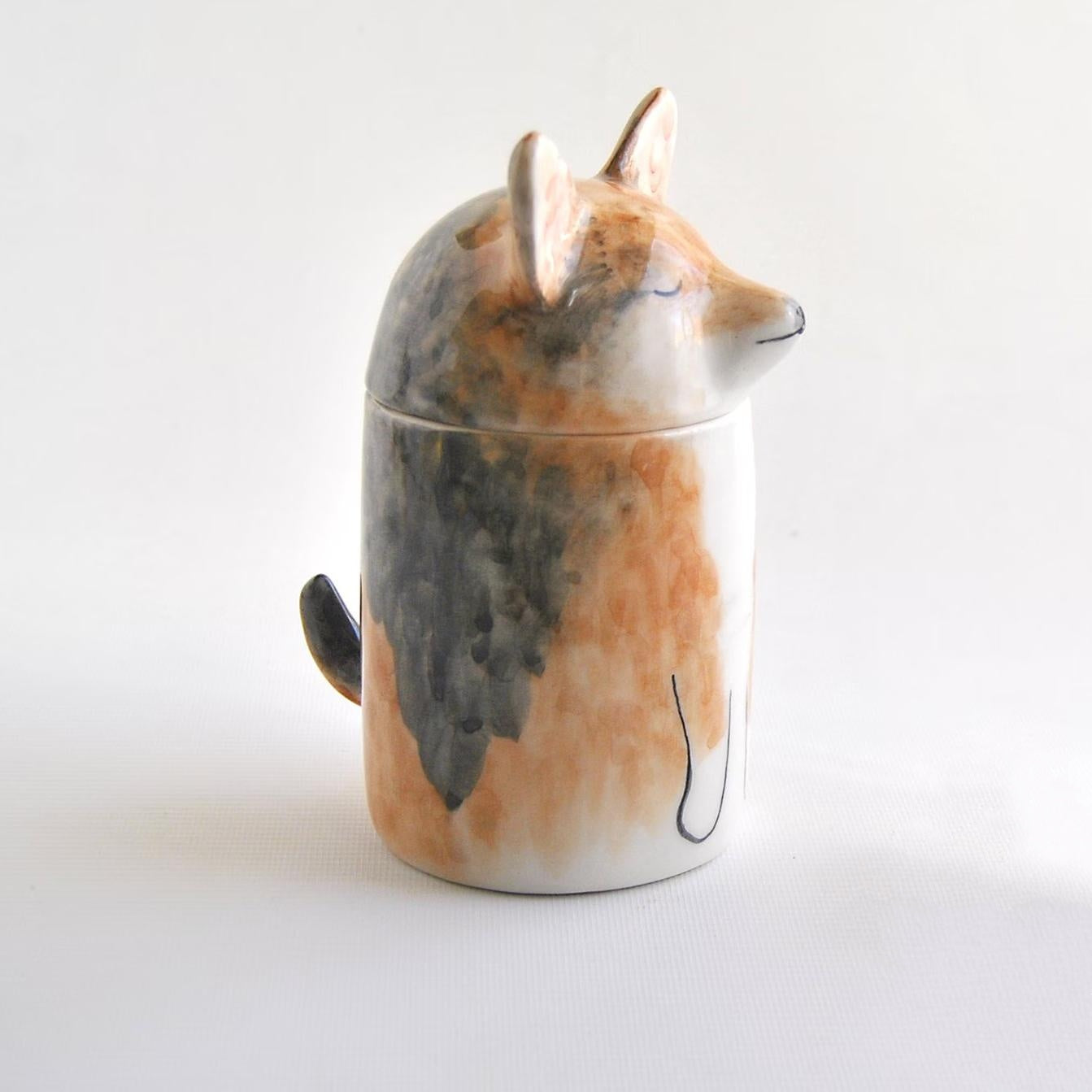 Ceramic fox-shaped container on a white background