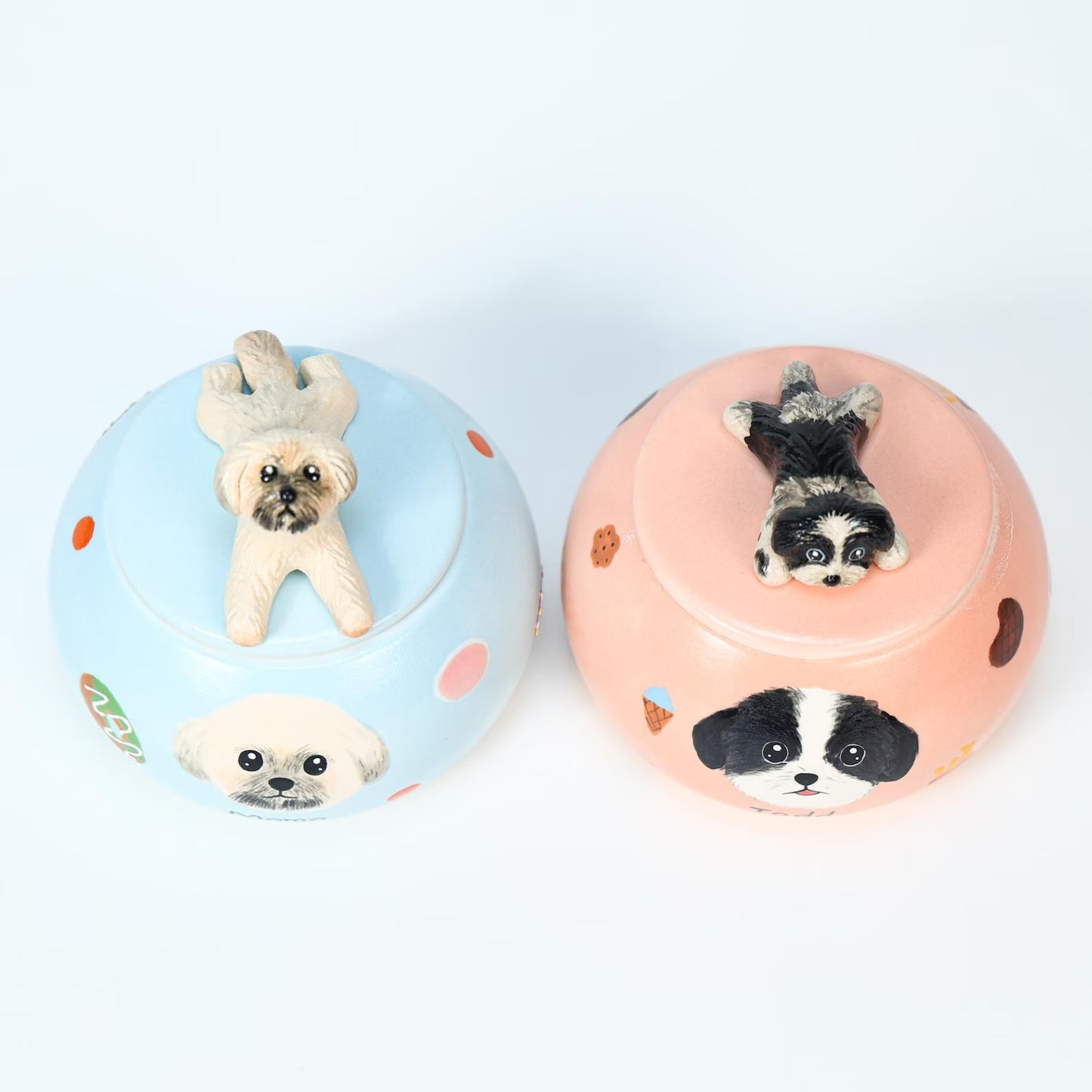 Two small ceramic urn with dog illustrations on a white background